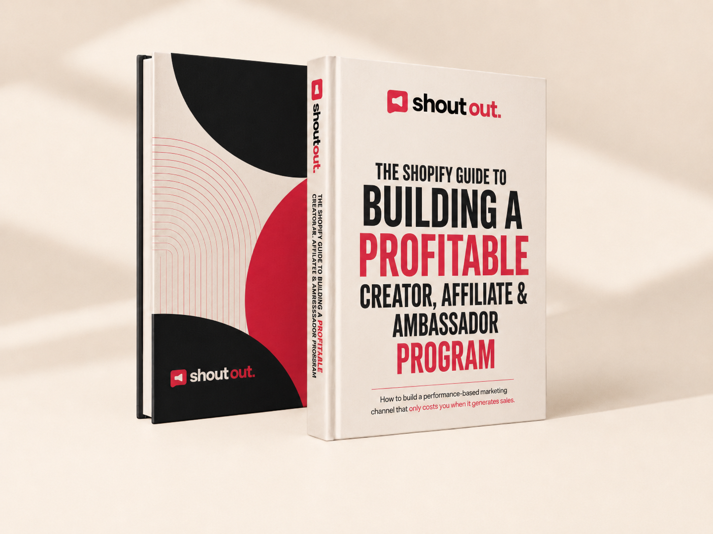 Two hardcover copies of the Shoutout Shopify guide to building a profitable creator, affiliate and ambassador program